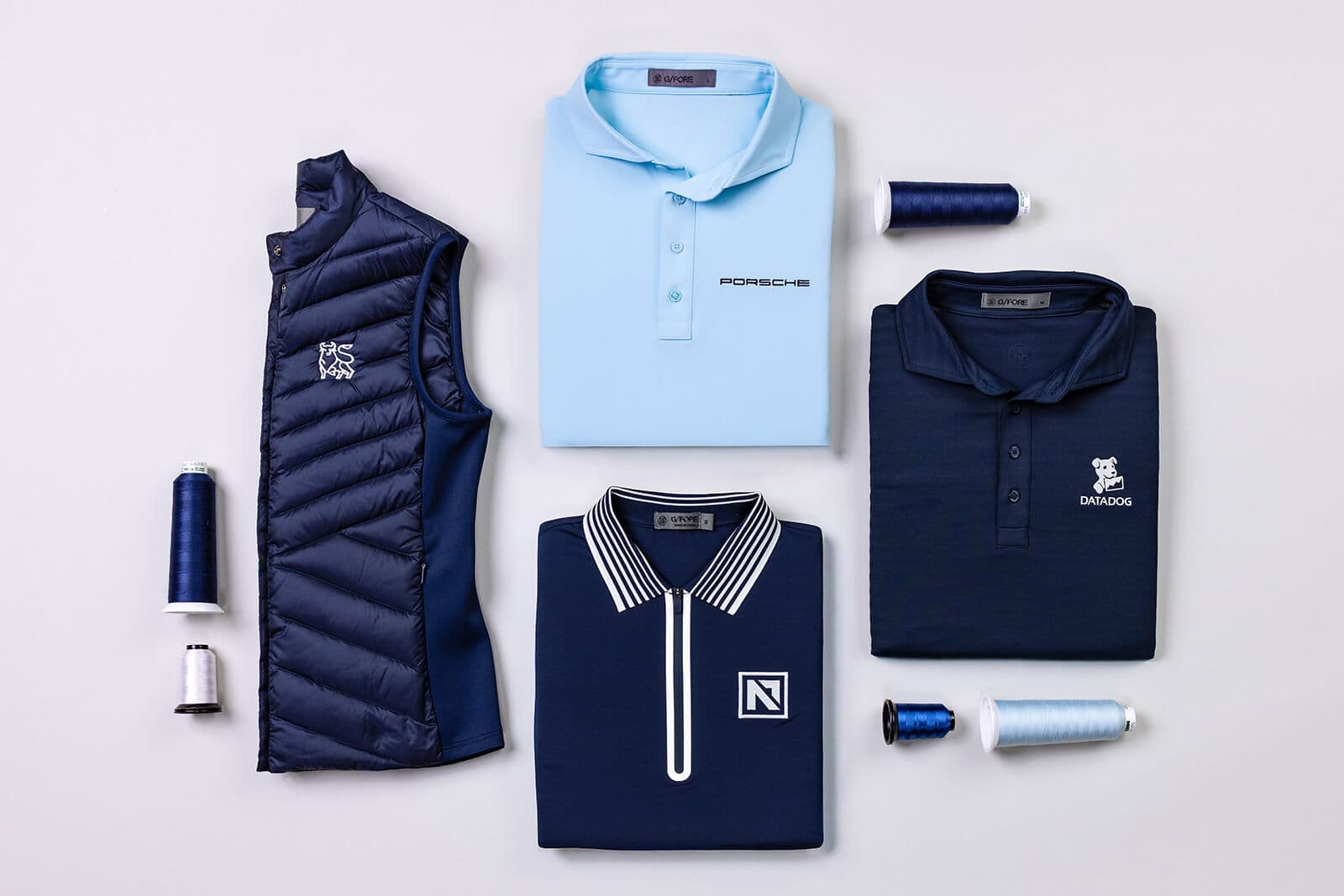 Custom embroidered polos, vests, and tees with company logos.